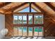 Bright living room with soaring wood ceilings and large windows overlooking the pool at 1101 Bay Pine Blvd, Indian Rocks Beach, FL 33785