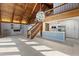 Open floor plan with vaulted wood ceiling, fireplace, staircase, and modern white kitchen at 1101 Bay Pine Blvd, Indian Rocks Beach, FL 33785