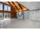 Spacious living room featuring vaulted ceilings, a modern fireplace, and sliding glass doors to the pool at 1101 Bay Pine Blvd, Indian Rocks Beach, FL 33785