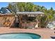 Poolside grill area with seating, ideal for entertaining guests outdoors on the pool brick patio at 1101 Bay Pine Blvd, Indian Rocks Beach, FL 33785