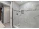 Elegant shower featuring marble tiles, glass enclosure, and a mosaic accent stripe at 1101 Bay Pine Blvd, Indian Rocks Beach, FL 33785