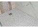 Close-up of a modern walk-in shower, showcasing designer tile and a sleek, functional design at 1101 Bay Pine Blvd, Indian Rocks Beach, FL 33785