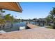 Scenic waterfront home view showcasing a private dock, calm waters, and lush tropical landscaping at 1101 Bay Pine Blvd, Indian Rocks Beach, FL 33785