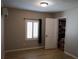 A gray-walled bedroom featuring a window, closet, and laminate floors at 11233 51St N Ave, St Petersburg, FL 33708