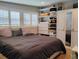Comfortable bedroom with hardwood floors, ample storage, natural light, and closet with a mirrored door at 11233 51St N Ave, St Petersburg, FL 33708