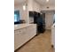 Well-appointed kitchen featuring white cabinets, stainless steel appliances, island with quartz countertops, and modern lighting at 11233 51St N Ave, St Petersburg, FL 33708