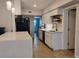Modern kitchen showcases white cabinets, sleek countertops, black appliances, and a functional island for meal prep at 11233 51St N Ave, St Petersburg, FL 33708