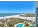Breathtaking aerial view of the beach, ocean, and community pool, a luxurious coastal living experience at 1180 Gulf Blvd # 1201, Clearwater, FL 33767