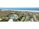 Expansive aerial view of beachside resort featuring a pool, palms and direct beach access at 1180 Gulf Blvd # 1201, Clearwater, FL 33767