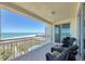 Enjoy gulf views from this balcony, complete with tiled floors, seating and white railings at 1180 Gulf Blvd # 1201, Clearwater, FL 33767