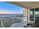 Enjoy gulf views from this balcony, complete with tiled floors, seating and white railings at sunset at 1180 Gulf Blvd # 1201, Clearwater, FL 33767