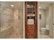 Elegant bathroom featuring a glass shower, built-in storage, and stylish fixtures at 1180 Gulf Blvd # 1201, Clearwater, FL 33767