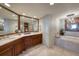 This gorgeous bathroom features dual sinks, marble countertops, and a standalone soaking tub at 1180 Gulf Blvd # 1201, Clearwater, FL 33767