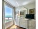 Bedroom dresser with stylish decor and a large window overlooking the ocean at 1180 Gulf Blvd # 1201, Clearwater, FL 33767