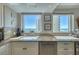 Bright kitchen featuring granite countertops, stainless steel dishwasher, and a stunning ocean view at 1180 Gulf Blvd # 1201, Clearwater, FL 33767