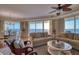 Bright, open-plan living room with ocean views, hardwood floors, and comfortable seating at 1180 Gulf Blvd # 1201, Clearwater, FL 33767