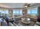 Bright, open-plan living room with ocean views, hardwood floors, and comfortable seating at 1180 Gulf Blvd # 1201, Clearwater, FL 33767