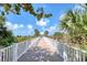 Charming beach access walkway with beautiful views and tropical foliage at 1180 Gulf Blvd # 1201, Clearwater, FL 33767