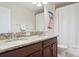 Bright bathroom featuring a double vanity with granite countertop and a shower with a white curtain at 12239 Crestridge Loop, New Port Richey, FL 34655