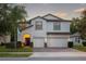 Charming two-story home featuring a well-manicured lawn and a three-car garage at 12239 Crestridge Loop, Trinity, FL 34655