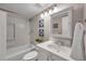 Bright bathroom featuring vanity, storage, and shower/tub combo at 1398 Shady Pine Way # H2, Tarpon Springs, FL 34688