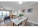 Bright dining area adjacent to the living room with access to outdoor balcony at 1398 Shady Pine Way # H2, Tarpon Springs, FL 34688