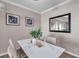 Dining room area featuring a modern table setting with decor and stylish framed wall art at 1398 Shady Pine Way # H2, Tarpon Springs, FL 34688