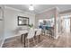 Bright dining area with modern table, chairs and decor next to a kitchen with stainless steel appliances and breakfast bar at 1398 Shady Pine Way # H2, Tarpon Springs, FL 34688