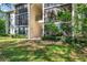 Exterior view of a two-story property with an exterior staircase and walkway at 1398 Shady Pine Way # H2, Tarpon Springs, FL 34688