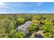 A high angle view of the apartments surrounded by beautiful lush trees at 1398 Shady Pine Way # H2, Tarpon Springs, FL 34688