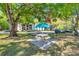 A picnic area with table and umbrella is located on the landscaped grounds at 1398 Shady Pine Way # H2, Tarpon Springs, FL 34688