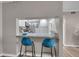 Kitchen view with breakfast bar seating, stainless appliances, and pass-through to the living space at 1398 Shady Pine Way # H2, Tarpon Springs, FL 34688