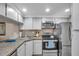 Bright kitchen with stainless steel appliances, ample storage, and a modern design at 1398 Shady Pine Way # H2, Tarpon Springs, FL 34688