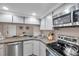 Open kitchen view into dining area, featuring stainless appliances and ample counter space at 1398 Shady Pine Way # H2, Tarpon Springs, FL 34688