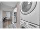 Hallway featuring stacked Washer/Dryer and view to dining area at 1398 Shady Pine Way # H2, Tarpon Springs, FL 34688