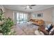 Cozy living room featuring stylish decor, natural light, and access to a private balcony at 1398 Shady Pine Way # H2, Tarpon Springs, FL 34688