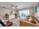 Cozy living room featuring stylish decor, natural light, and access to an outdoor balcony at 1398 Shady Pine Way # H2, Tarpon Springs, FL 34688