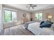 Inviting main bedroom with hardwood floors, neutral walls, and sun-drenched windows at 1398 Shady Pine Way # H2, Tarpon Springs, FL 34688
