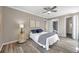 Relaxing main bedroom with hardwood floors, soft colors, and a doorway to the bathroom at 1398 Shady Pine Way # H2, Tarpon Springs, FL 34688