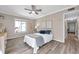 Comfortable bedroom with hardwood floors, ceiling fan, and a large window for natural light at 1398 Shady Pine Way # H2, Tarpon Springs, FL 34688