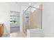 Modern bathroom featuring glass-enclosed shower and light-colored tile work and double doors leading to another room at 14180 Samoa Hill Ct, Riverview, FL 33569