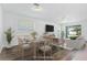 Bright dining area with wood floors, table for six, and sliding glass doors to the outdoor living space at 14180 Samoa Hill Ct, Riverview, FL 33569
