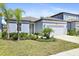 Well-maintained single-Gathering home with beautiful landscaping, a two-car garage, and a walkway to the entrance at 14180 Samoa Hill Ct, Riverview, FL 33569