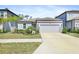 Charming single-story home featuring a well-manicured lawn, a two car garage, and beautiful landscaping at 14180 Samoa Hill Ct, Riverview, FL 33569