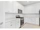 Bright kitchen features white cabinetry and stainless steel appliances at 14180 Samoa Hill Ct, Riverview, FL 33569