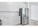 Kitchen with white cabinets and stainless steel refrigerator at 14180 Samoa Hill Ct, Riverview, FL 33569