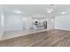 Open-concept living area with wood floors connecting to kitchen at 14180 Samoa Hill Ct, Riverview, FL 33569