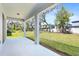 Covered patio overlooking a large backyard with green grass and trees at 14180 Samoa Hill Ct, Riverview, FL 33569