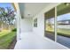 A covered patio features a view of green grass and a side yard with partial fence at 14180 Samoa Hill Ct, Riverview, FL 33569