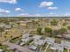 High-angle view of community showcasing condos, lovely pond, and nearby amenities under a bright blue sky with fluffy clouds at 1801 Bedford Ter # 221, Sun City Center, FL 33573